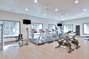 A gym full of cardio equipment and exercise bikes
